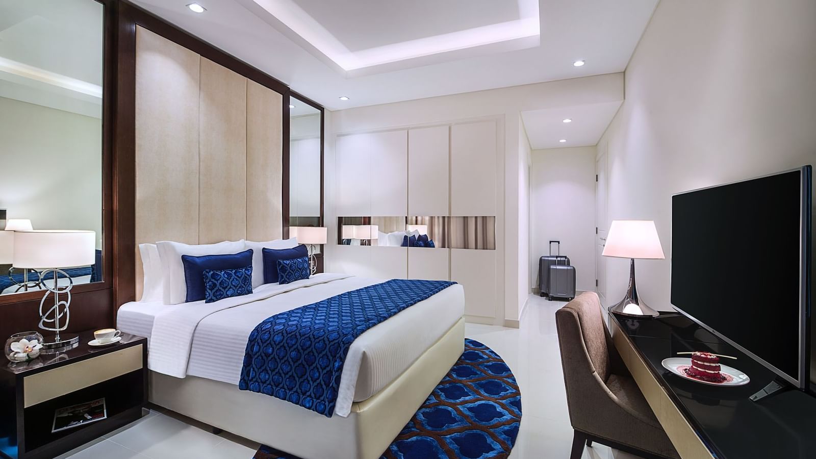 King-size bed, work desk & a TV in Two Bedroom Suite at DAMAC Maison Distinction