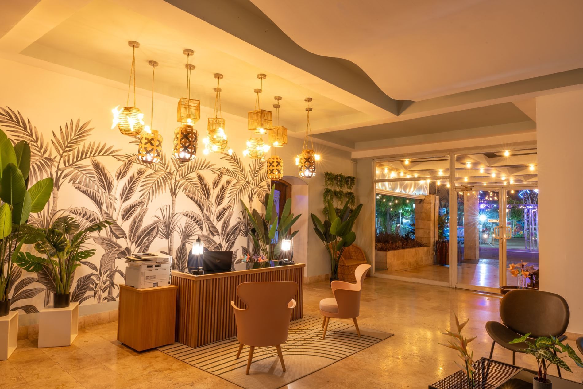 Lobby with tropical wallpaper, stylish seating, and unique pendant lights at Panama city hotels