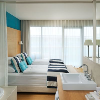 Superior Room seaside, Beds & vanity at Falkensteiner Hotels