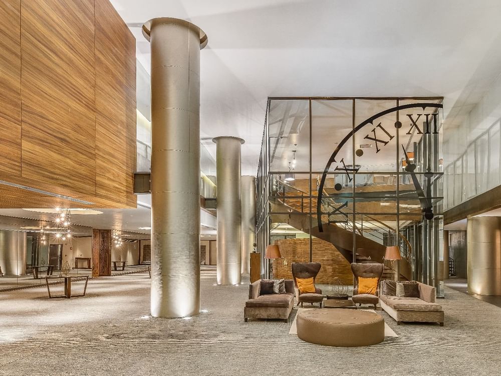 Lobby area with comfy seating & stairway at Live Aqua Resorts and Residence Club