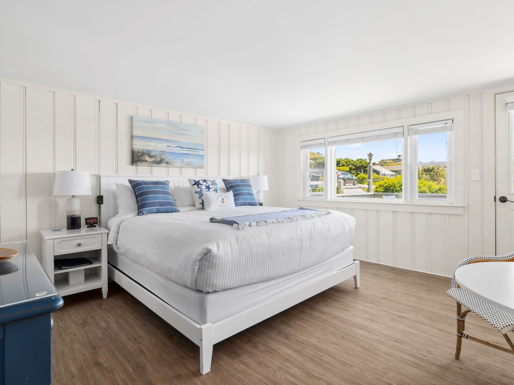 Nightstand by the king bed in Risingtide Oceanview King Efficiency at Chatham Tides Resort