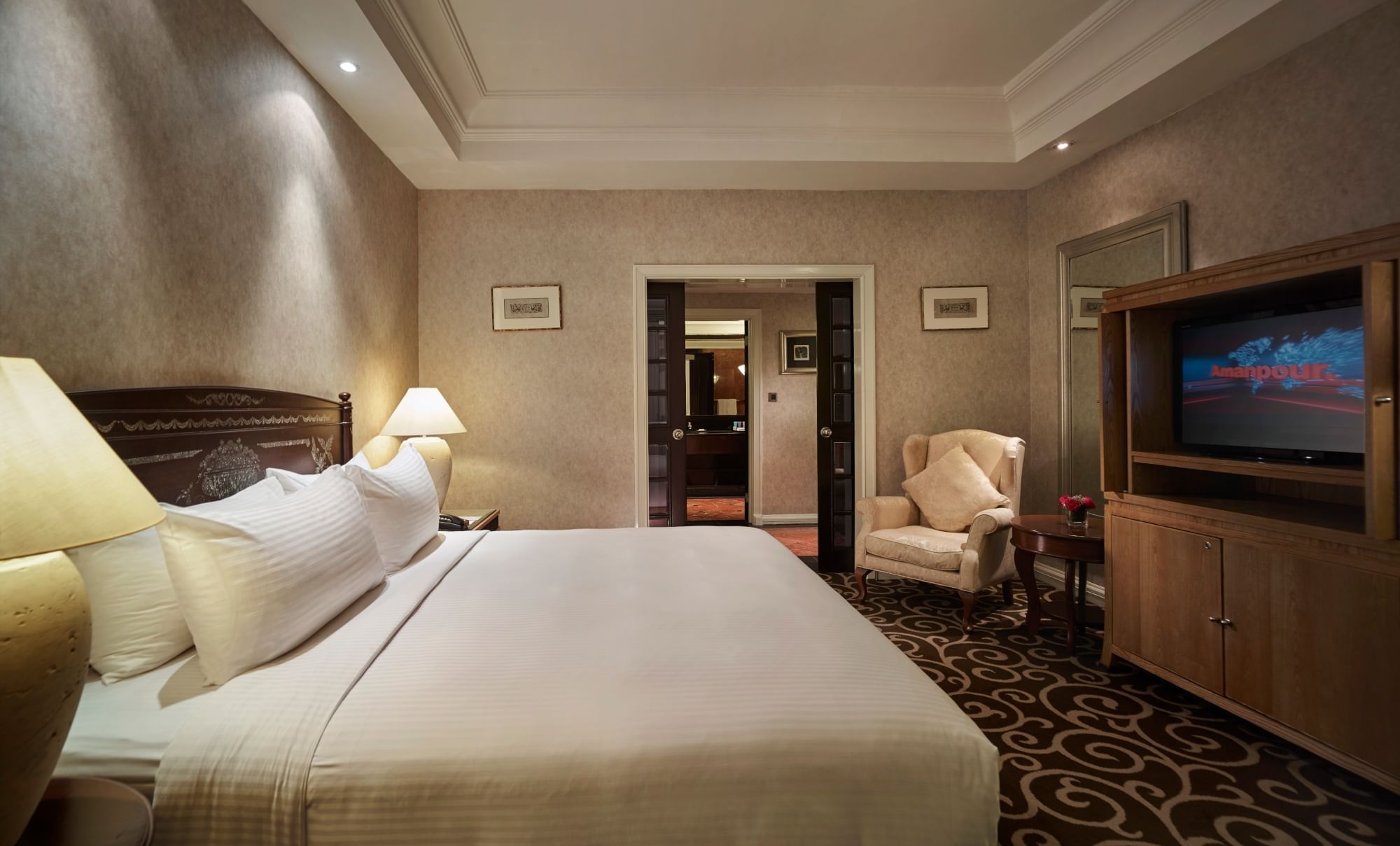 King-size bed with a TV in Classic Suite at Sunway Putra Hotel