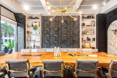 Conference room set up featuring artistic wall designs and wooden floors in the Business Center at The Riverwalk Plaza Hotel