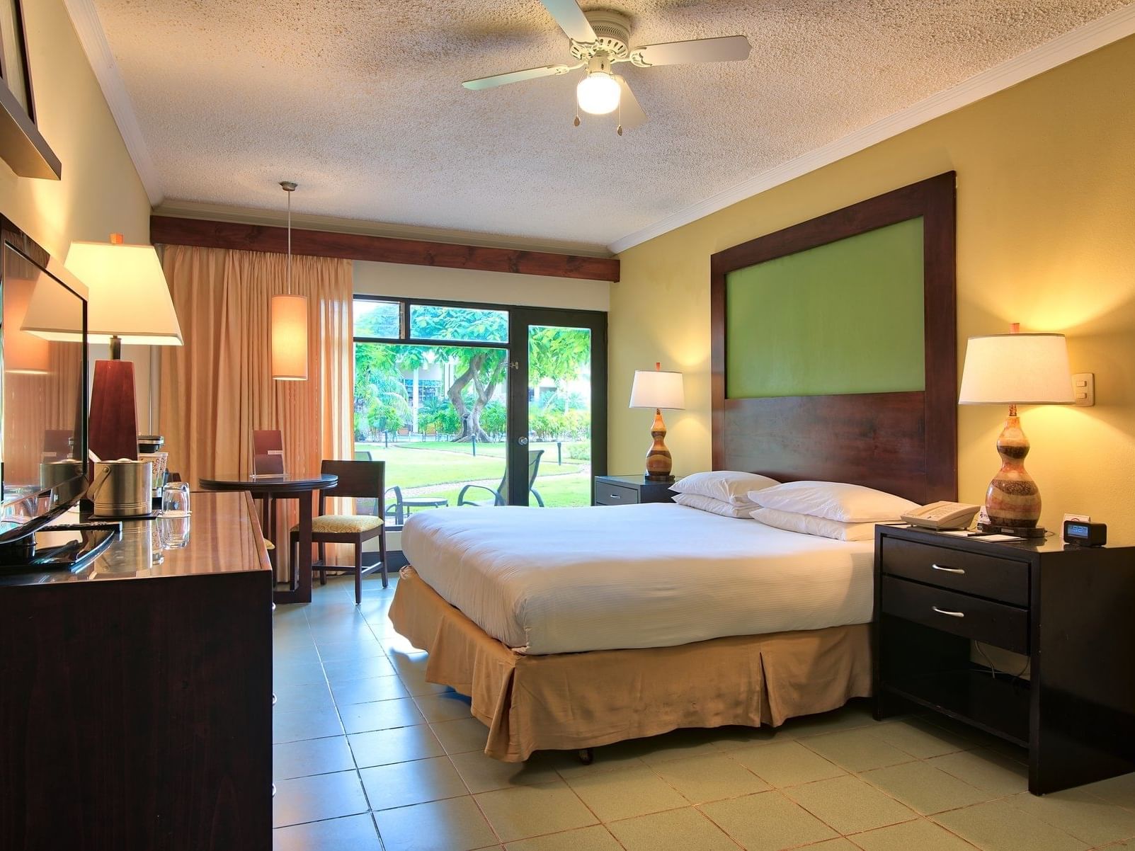 Interior view of Fiesta One King Bed with bedside lamps Room at Fiesta Resort