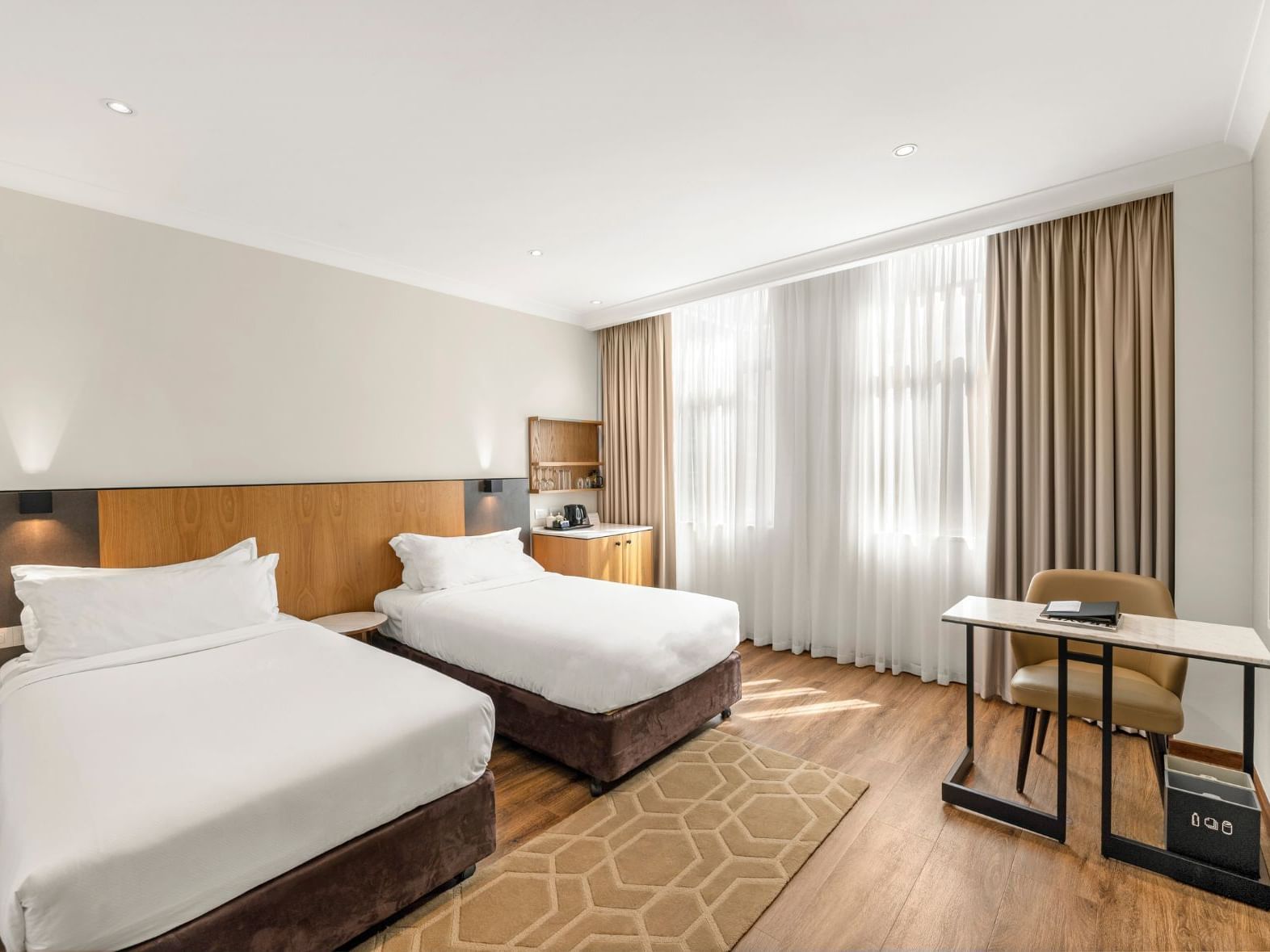 Twin beds, work desk & wooden floors in Signature Superior Twin Room in Grace Hotel