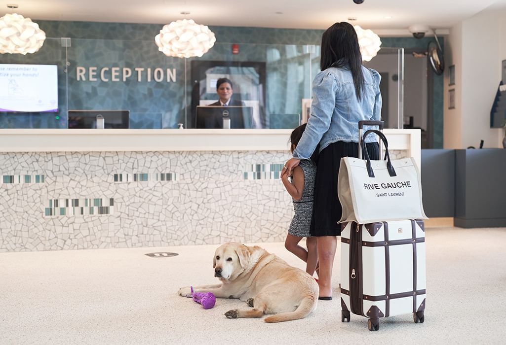 Guest checking in with a dog at the Coast Langley City Hotel