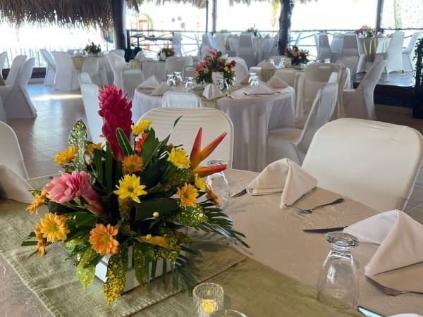 Table set up with floral decor in The Sailboat at Playa Blanca Beach Resort