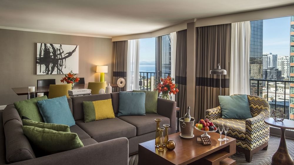 Large grey sectional sofa by a wooden coffee table in a modern living area in Emerald Suite at Warwick Seattle