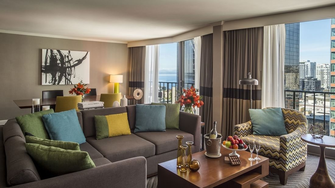 Large grey sectional sofa by a wooden coffee table in a modern living area in Emerald Suite at Warwick Seattle
