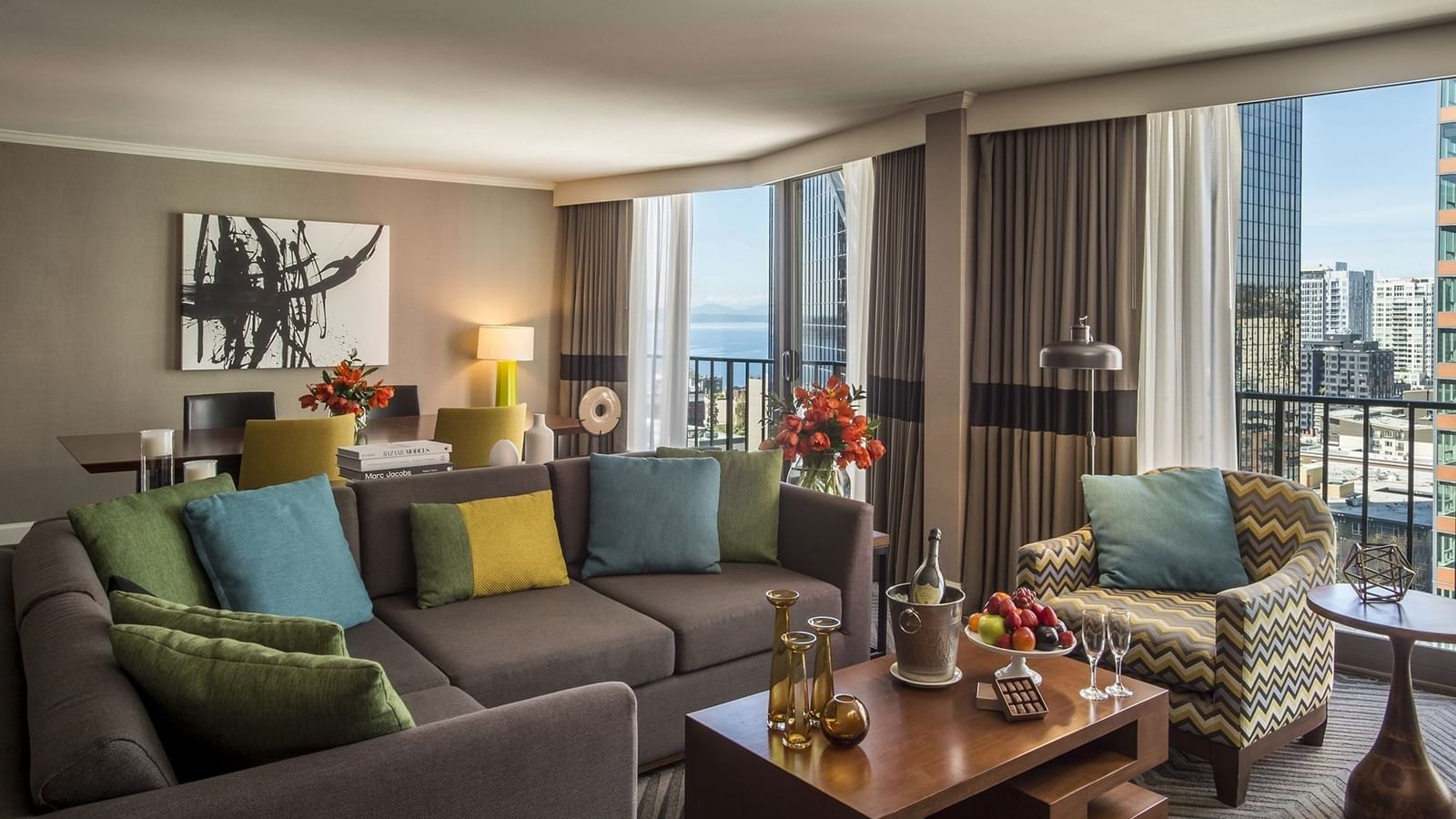 Large grey sectional sofa by a wooden coffee table in a modern living area in Emerald Suite at Warwick Seattle
