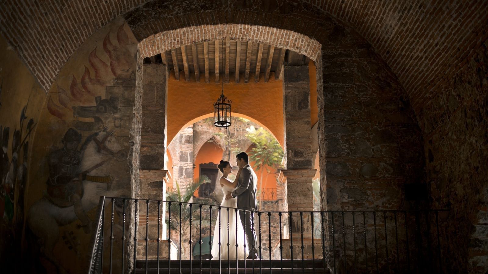 Wedded couple posing by a stairway at FA Hacienda San Antonio