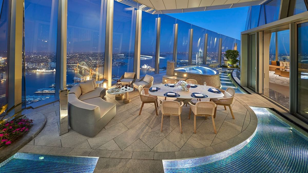 Luxury terrace with dining setup overlooking city skyline in Crown Presidential Villa at Crown Hotels