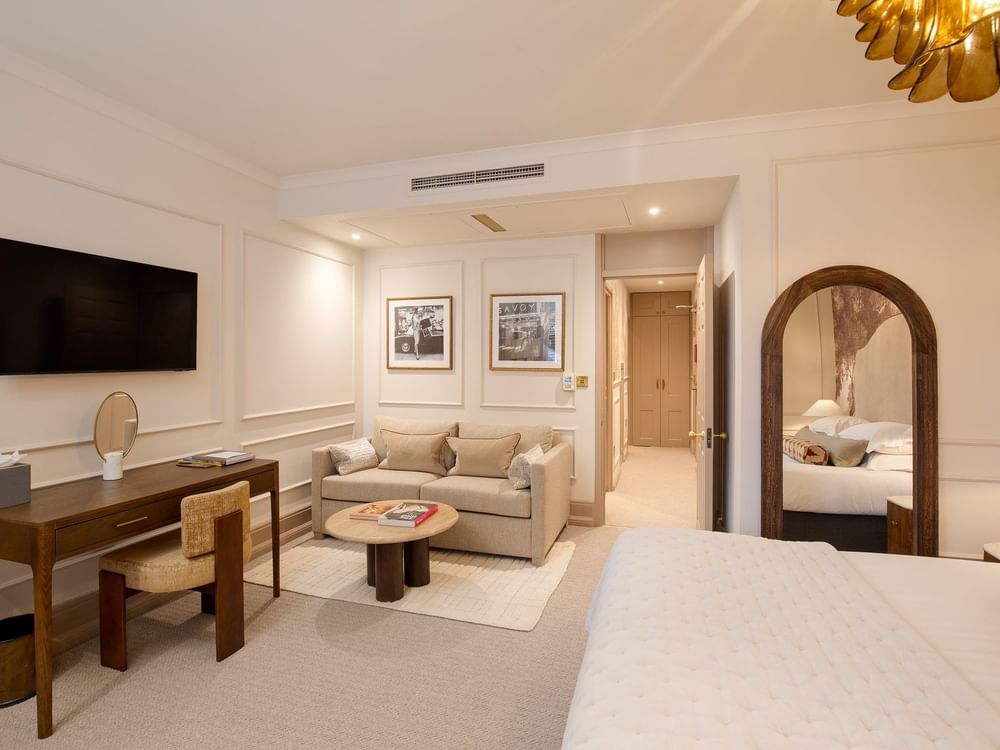 Studio Apartment TV lounge with a working desk near door at The Capital Hotel, Apartments and Townhouse