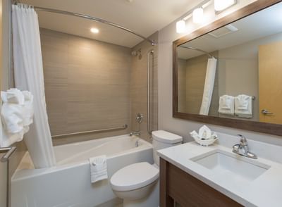 A full view of a clean and spacious bathroom with a bathtub at the Embassy Inn Victoria