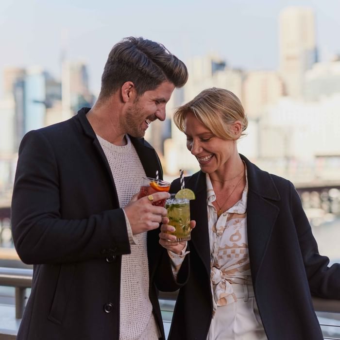 Couple enjoying sunset drinks on ibis bar deck