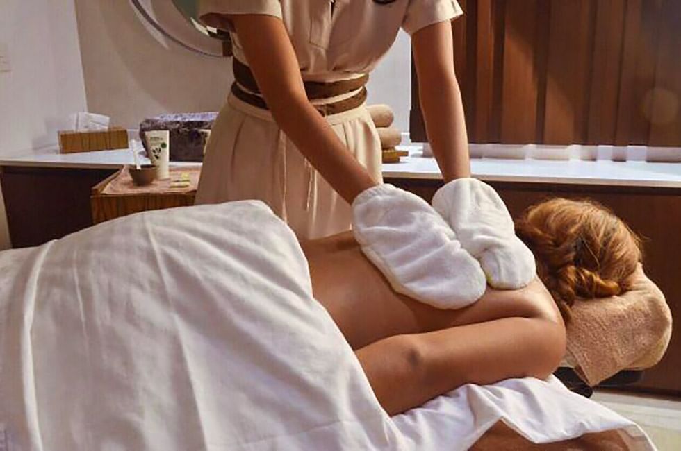 A woman having body treatments in Okom spa at The Reef 28