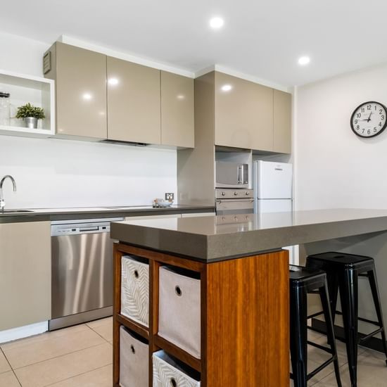 Kitchen with dining area in Deluxe Three Bedroom at Pullman Magenta Shores Resort