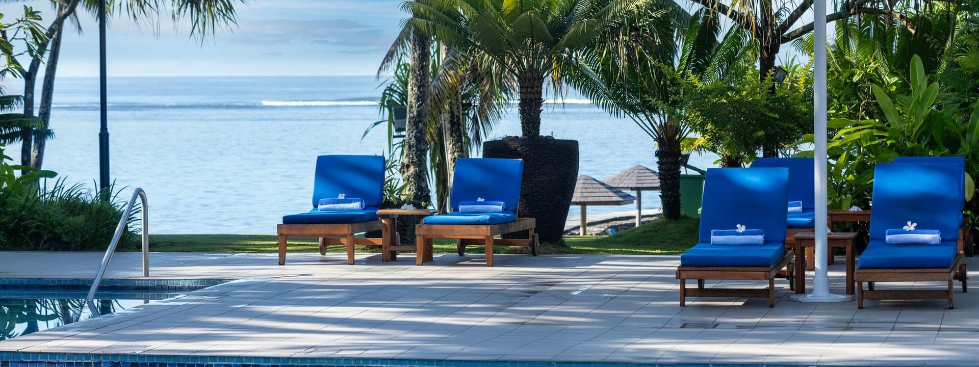 Blue loungers around adult only pool and bar at Warwick Fiji Resort and Spa in Korolevu