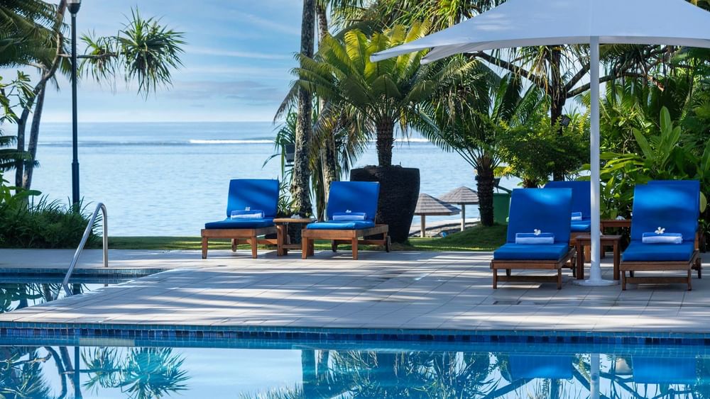 Blue loungers around adult only pool and bar at Warwick Fiji Resort and Spa in Korolevu
