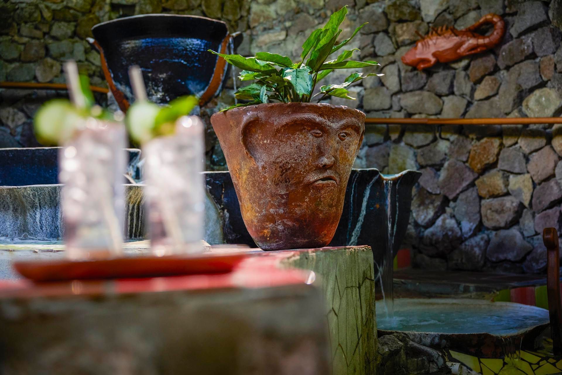 Two cocktail glasses served by the hot tub and a cement plant vase at Ladera Resort