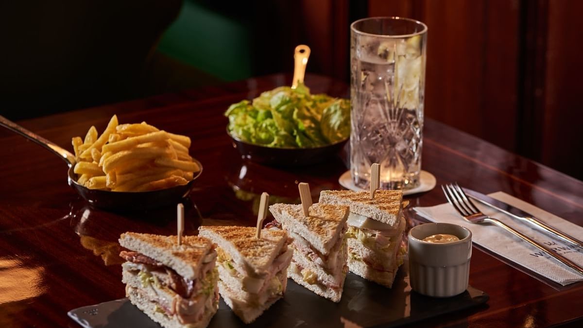 Close-up of sandwich, french fries, and salad served at Westminster Warwick Paris