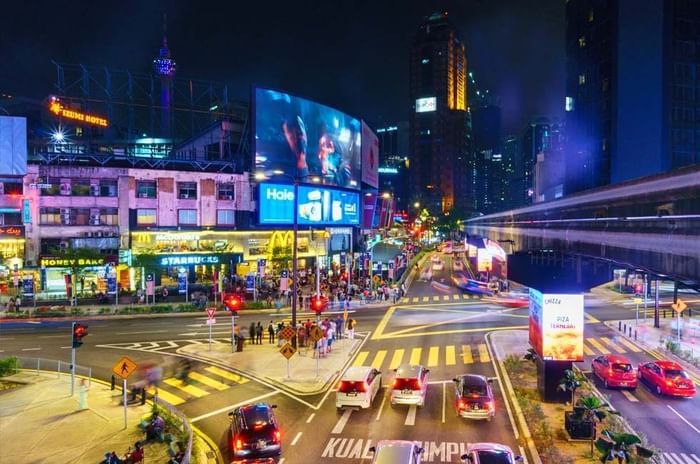 A bustling city street at night near Imperial Lexis accommodation Bintang Kuala Lumpur