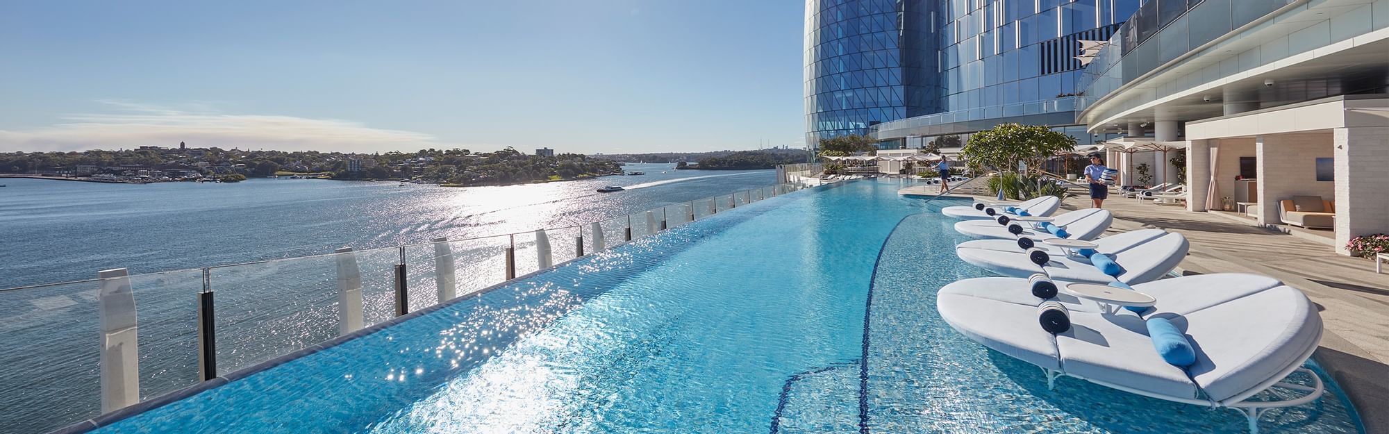 Swimming pool with sun loungers at Crown Towers Sydney