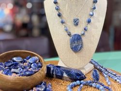 A blue stone necklace and necklace placed on a table at High Peaks Resort
