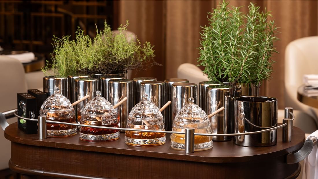 A set of shiny bar tools, ice buckets, and crystal honey jars at Sunway Resort