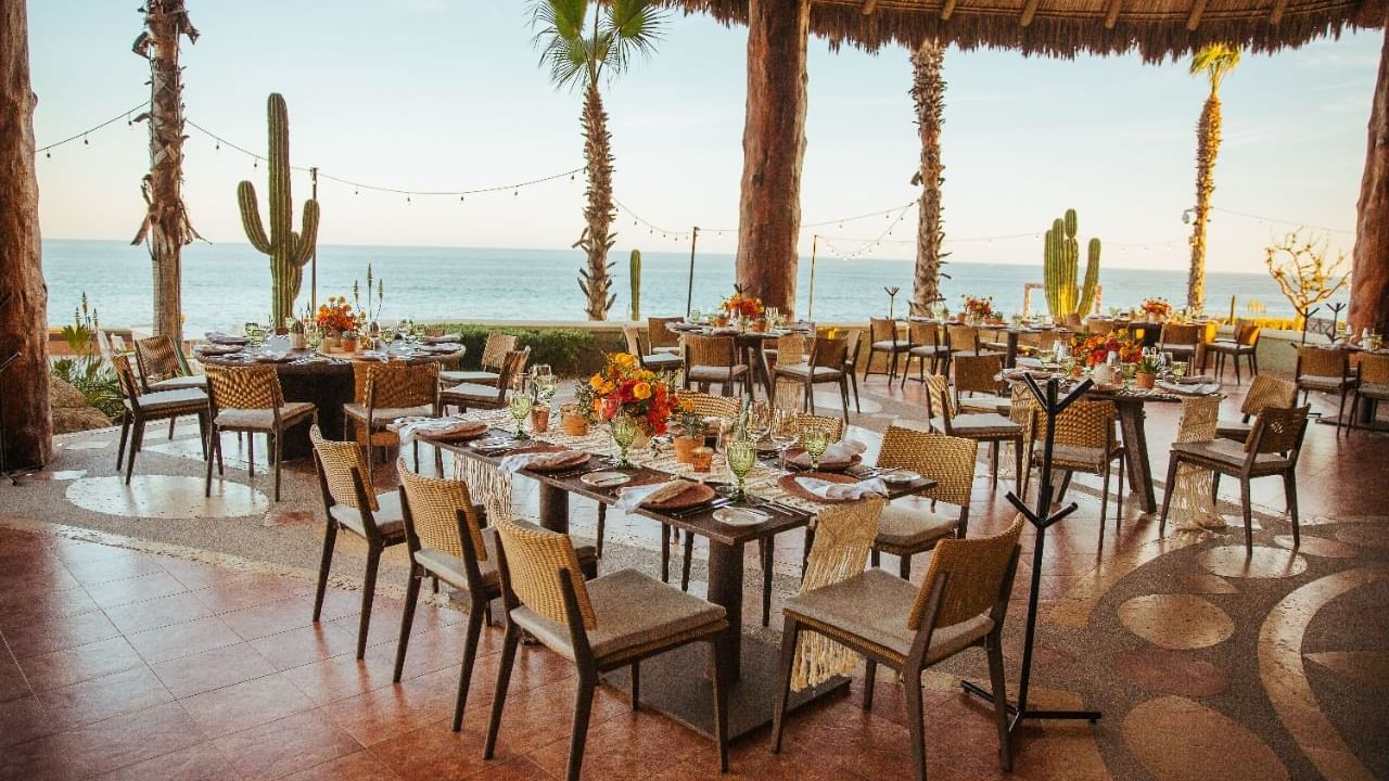Pitahayas outdoor Wedding reception with decorated tables and an ocean view at Hacienda del Mar Los Cabos