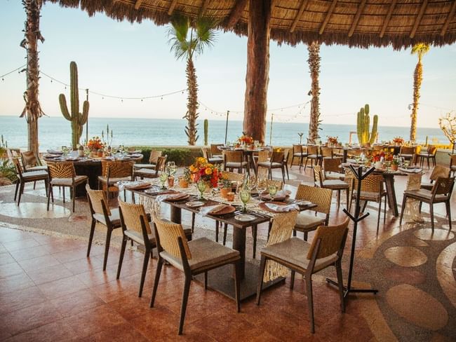 Pitahayas outdoor Wedding reception with decorated tables and an ocean view at Hacienda del Mar Los Cabos