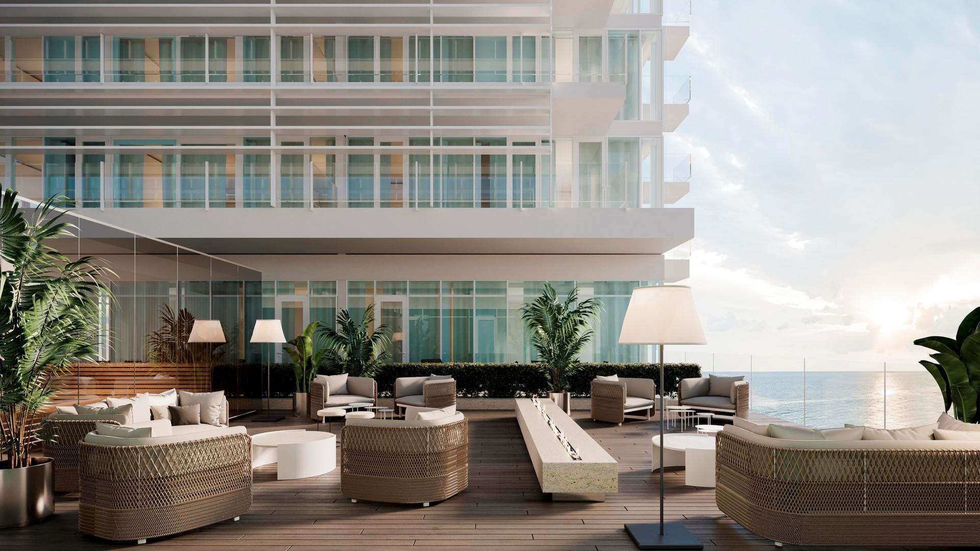 Terrace with stylish outdoor furniture overlooking the ocean at Falkensteiner Hotel & Spa Jesolo