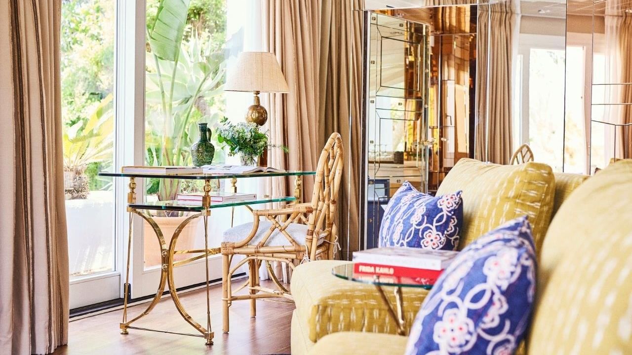 Villa del Mar with gold-framed glass desk by windows overlooking lush greenery at Marbella Club