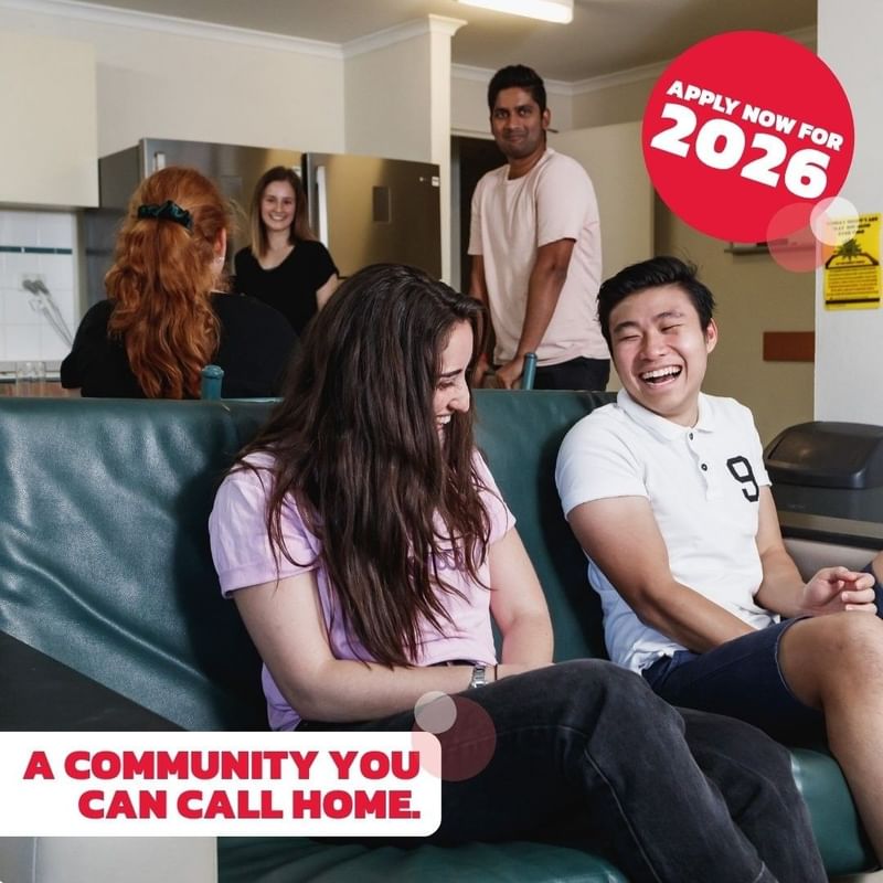 A group of young people socializing in a kitchen, with a slogan 