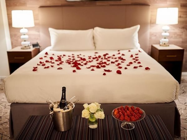 Romance Suite bedroom with rose petals at Warwick Denver