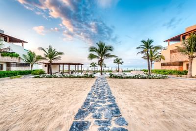 A rocky pathway by the beach near Marea Beachfront Villas