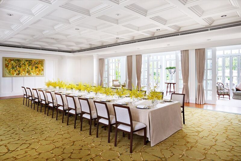 Long table arrangement with carpeted floors and opened doors leading to the Foyer at Park Hyatt Saigon