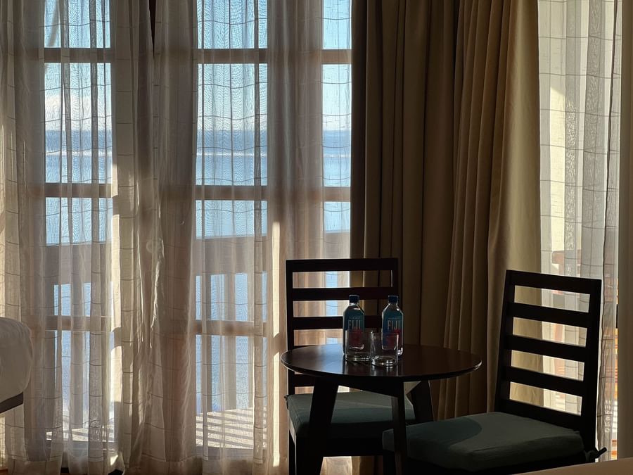 Small round table with two chairs and ocean view at Warwick Fiji Resort and Spa.