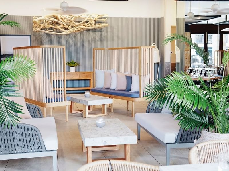 Aluco Restaurant with decorative plants, tables & chairs at Pullman Port Douglas