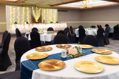 Elegant wedding banquet table featuring a light blue runner and silver plates at Rodd Grand Yarmouth