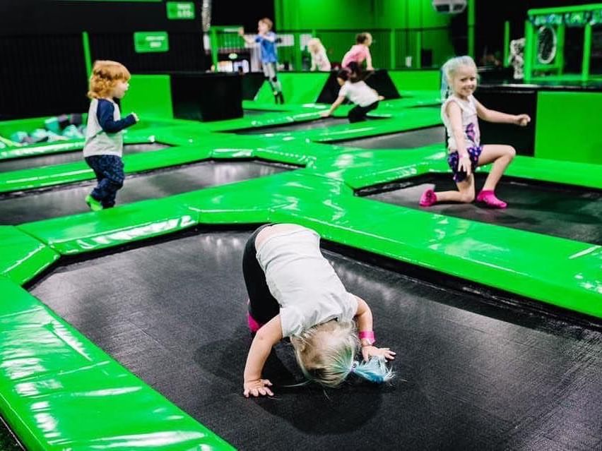 Kids joyfully jump and play on interconnected trampolines at Flip Out Mandurah near The Sebel Mandurah indoor park