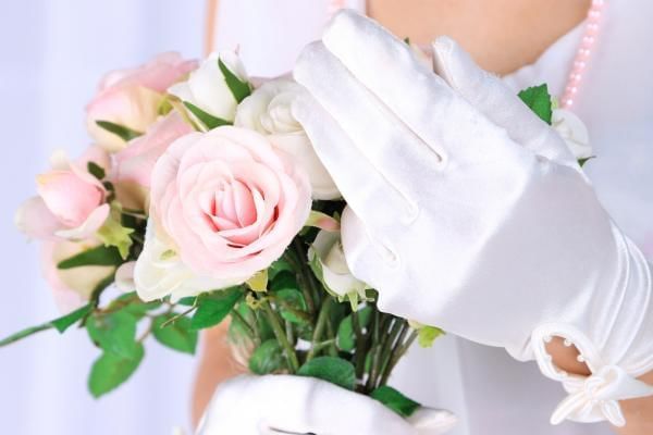 Bride wearing satin gloves a winter bridal accessory 