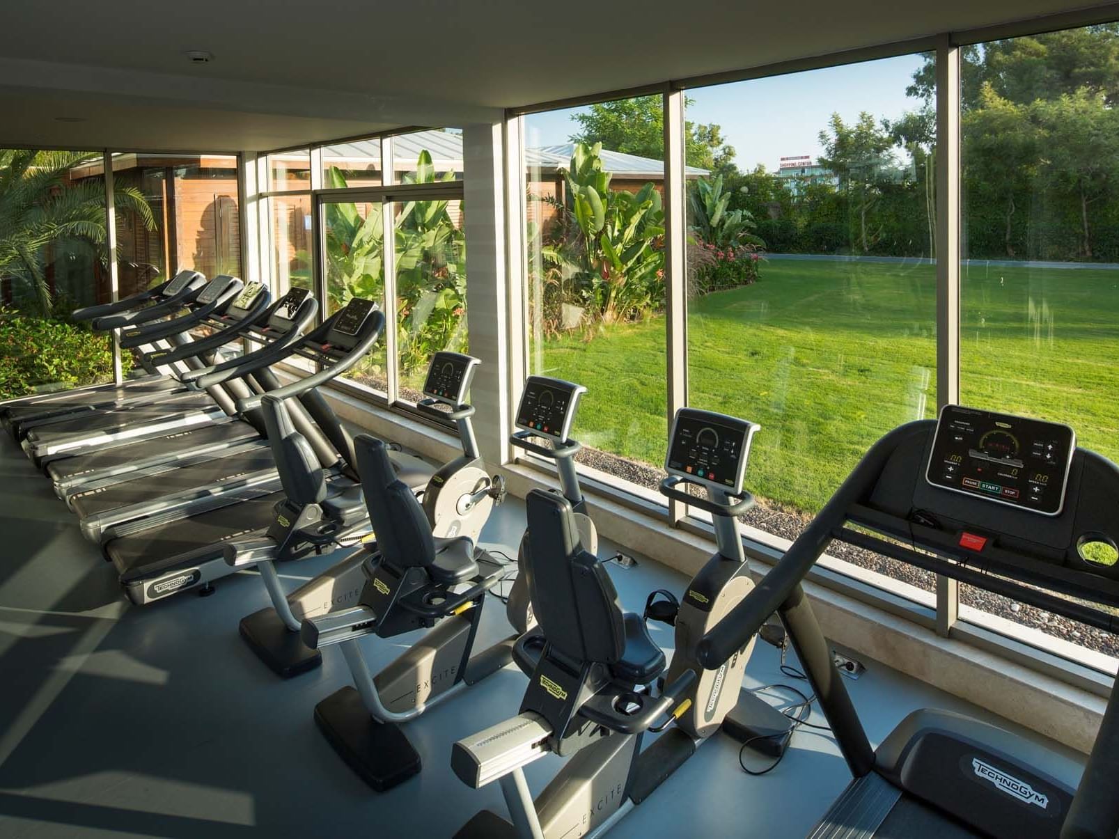 Treadmill machines lined up by the window in BeFine Fitness at Titanic Deluxe Lara