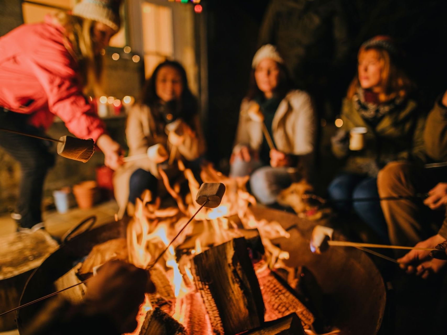 People roasting marshmallows over firepit at Chase on The Lake
