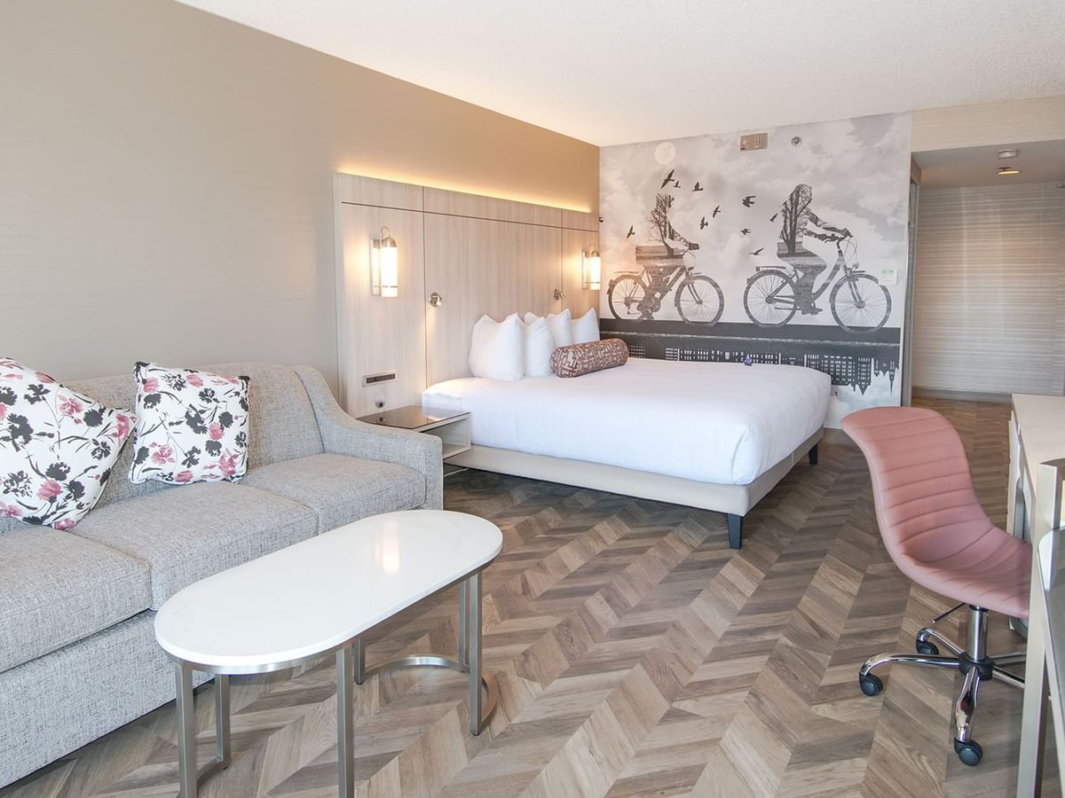 Hotel guestroom with king size bed, a sofa and coffee table