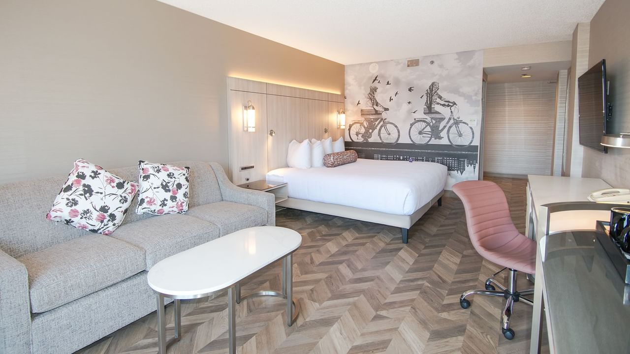 Hotel guestroom with king size bed, a sofa and coffee table