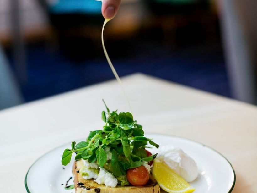 Decorating a food dish at Sebel Quay West Suites Sydney