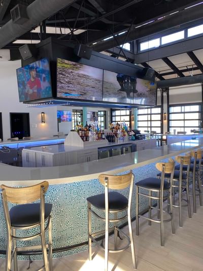 Off Shore Bar & Grill with a sleek countertop, stylish high chairs, and a well-stocked liquor shelf at Off Shore Resort