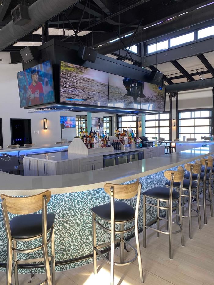 Restaurant Bar with high chairs and white counter tops at Off Shore Resort