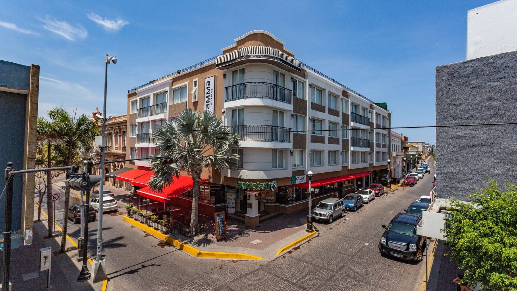An exterior view of the hotel & street at Gamma Hotels
